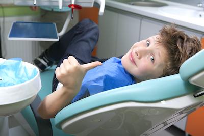 Kid giving a thumbs up in dentist chair, palos heights il