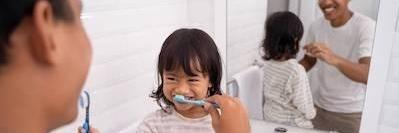 little girl brushing her teeth in palos heights il