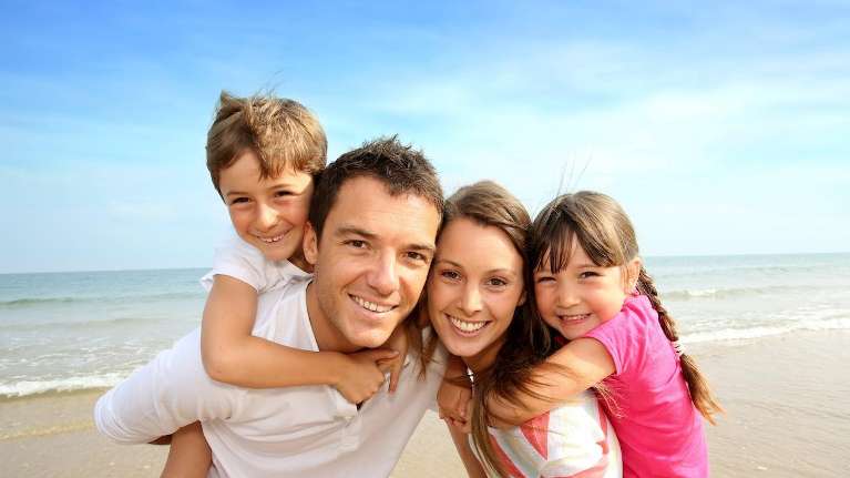Family smiling on a beach, palos heights IL