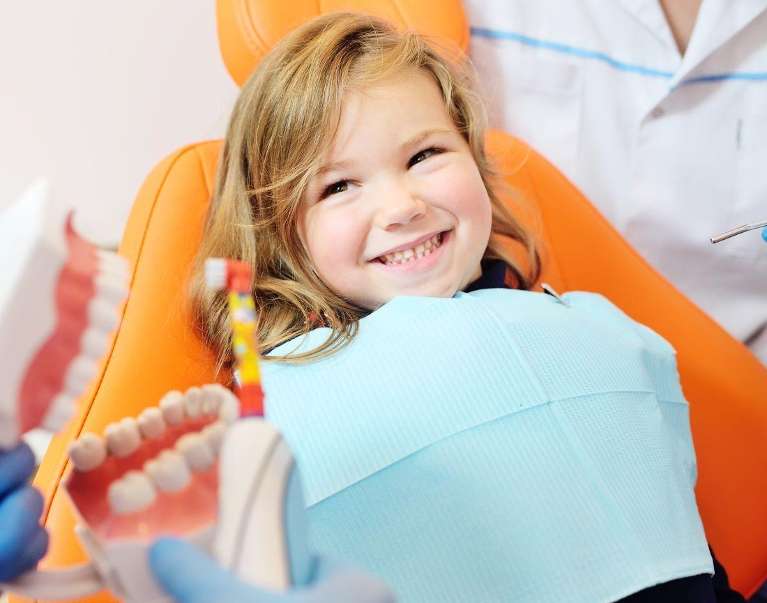 Young girl smiling in a dental chair, palos heights il