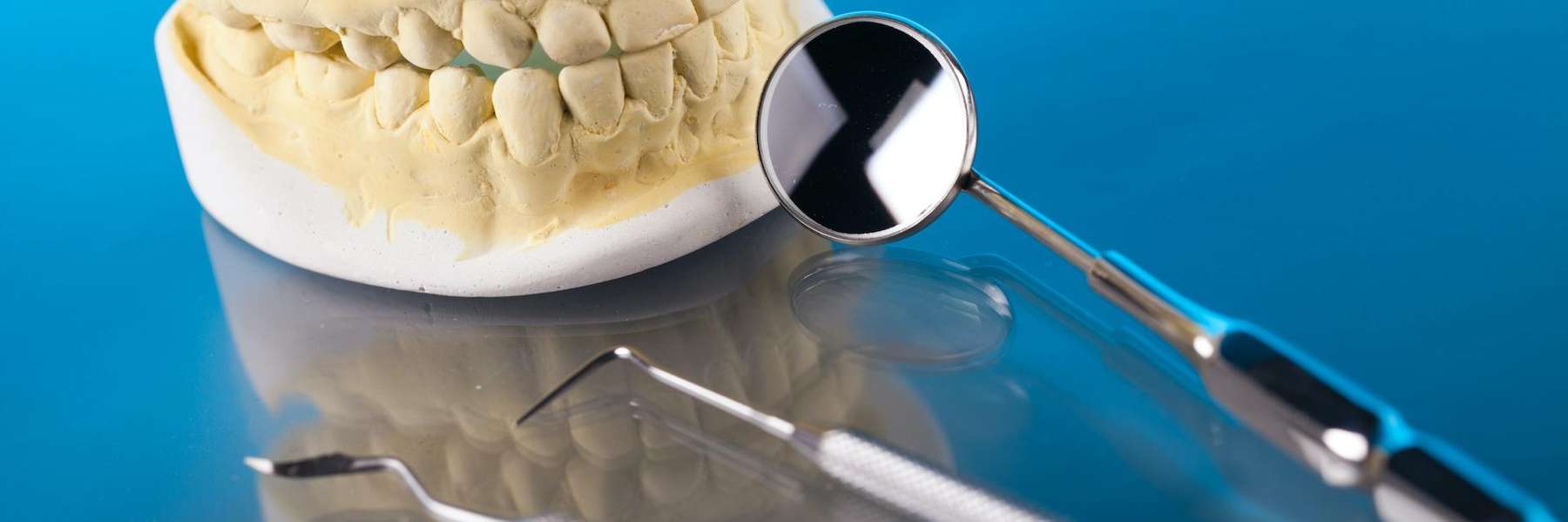 Dental tool next to a mold of teeth, palos heights il